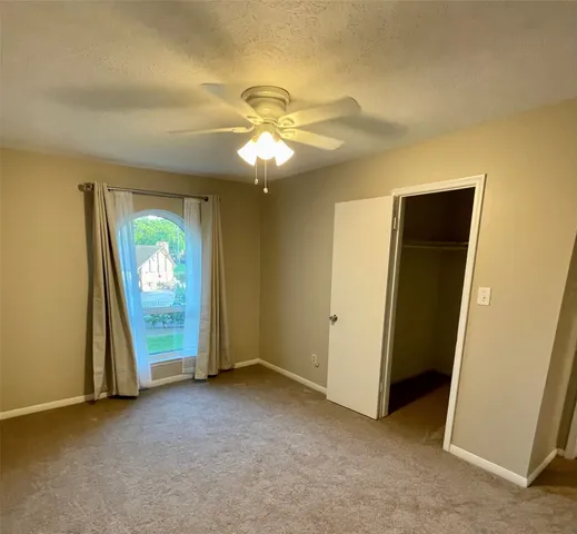 an empty room with windows and entrance