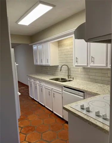 a kitchen with stainless steel appliances granite countertop a sink and a stove