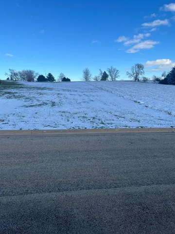 a view of dirt road with a building in the background