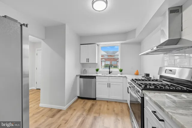 a kitchen with a stove a sink and a refrigerator