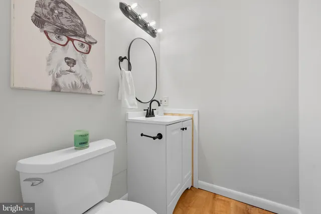 a bathroom with a sink mirror vanity and toilet