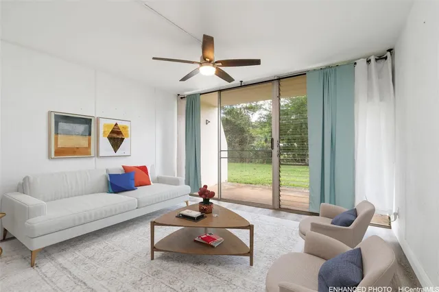a living room with furniture and a floor to ceiling window