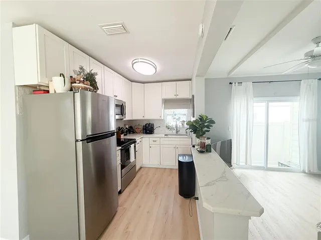 a kitchen with a refrigerator a sink and dishwasher