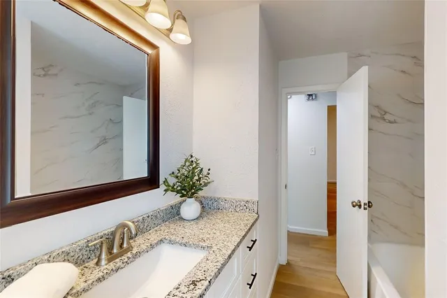 a view of a hallway with wooden floor