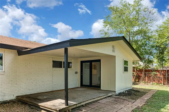 a house with green field in front of it