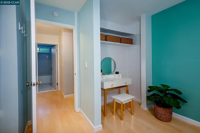 a view of a hallway and a livingroom with furniture