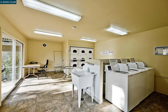 a living room with furniture and a dining table with rug