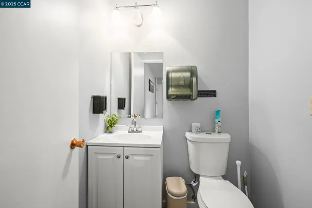 a bathroom with a sink toilet and mirror