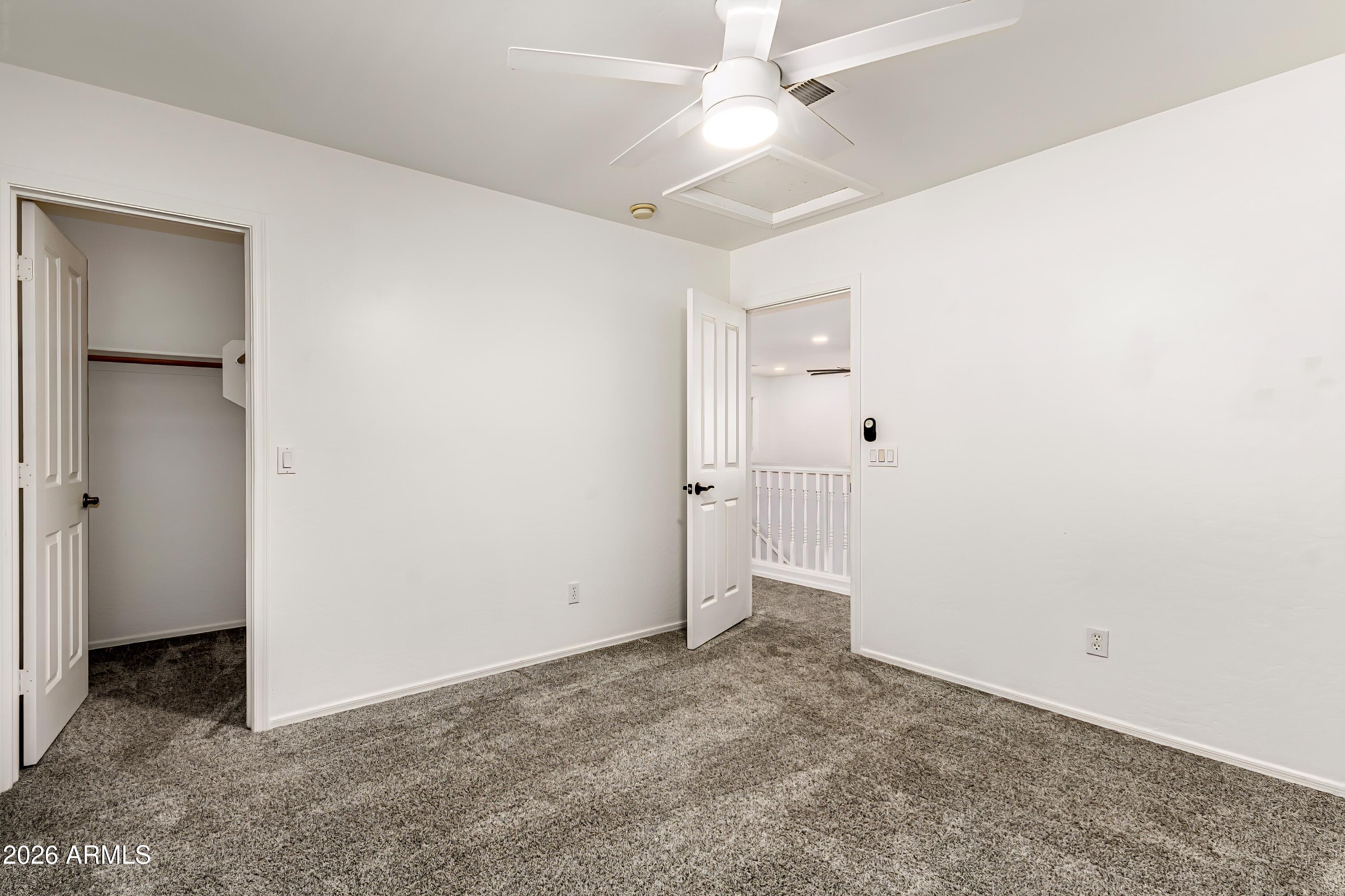 4208 South Sawmill Road Gilbert, AZ 85297 - Photo 26 of 46 an empty room with a ceiling fan and a bathroom
