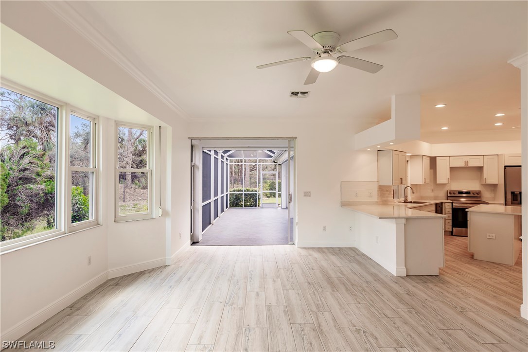 20600 Rivers Ford Estero, FL 33928 - Photo 11 of 28 a view of a kitchen with microwave and wooden floor