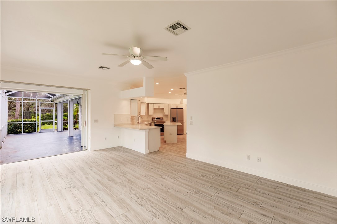 20600 Rivers Ford Estero, FL 33928 - Photo 12 of 28 a view of a kitchen with wooden floor and a ceiling fan