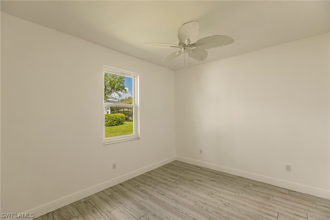 20600 Rivers Ford Estero, FL 33928 - Photo 19 of 28 an empty room with a window and wooden floor