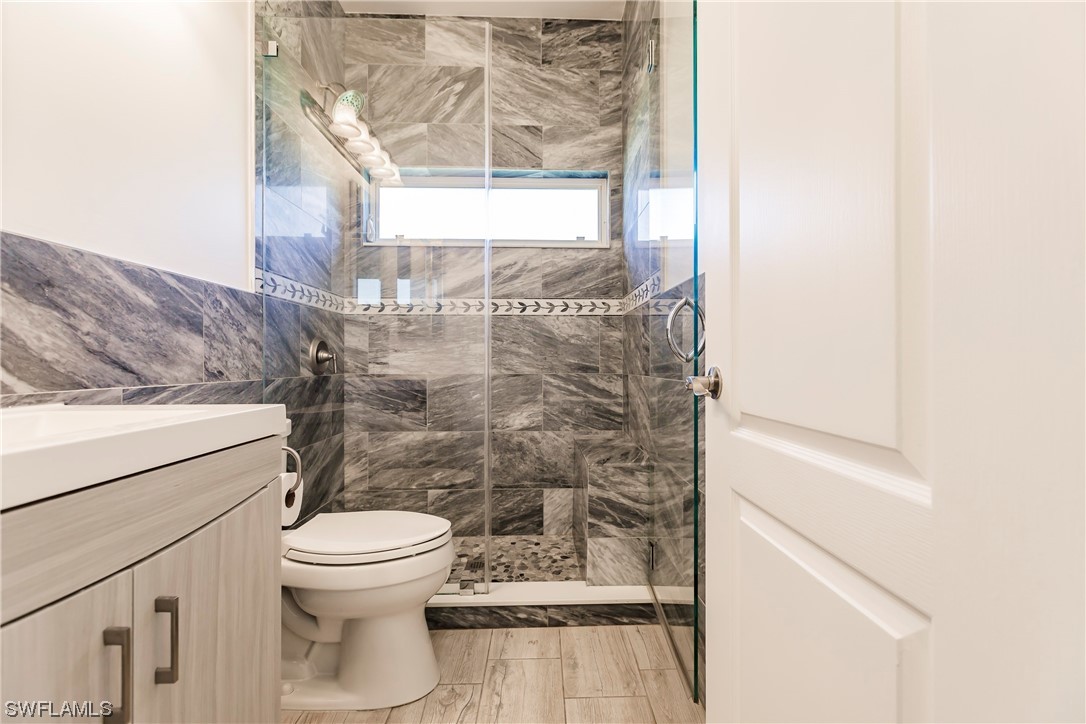 20600 Rivers Ford Estero, FL 33928 - Photo 20 of 28 a bathroom with a toilet and a shower