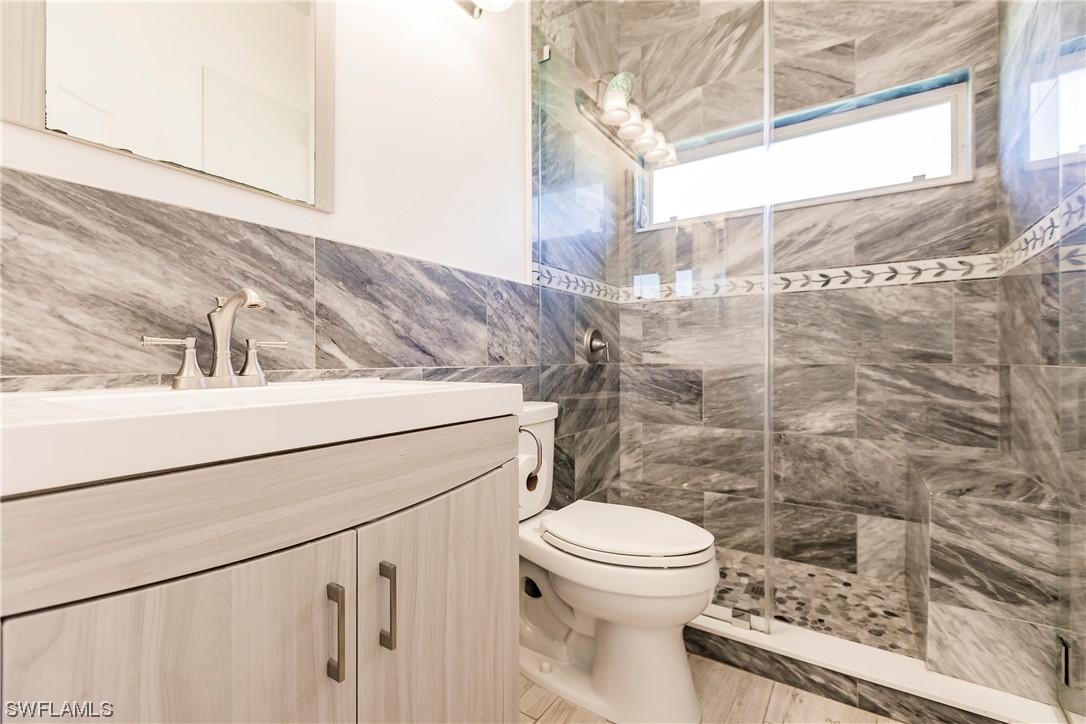 20600 Rivers Ford Estero, FL 33928 - Photo 21 of 28 a bathroom with a toilet a sink and a shower