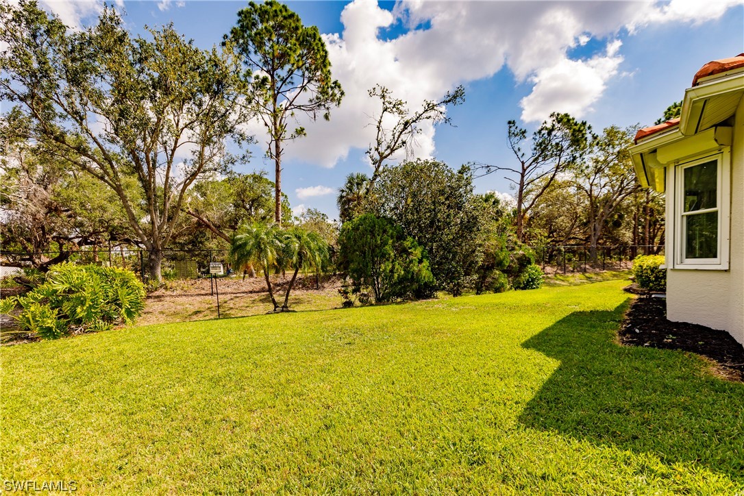 20600 Rivers Ford Estero, FL 33928 - Photo 27 of 28 a swimming pool with outdoor seating and yard