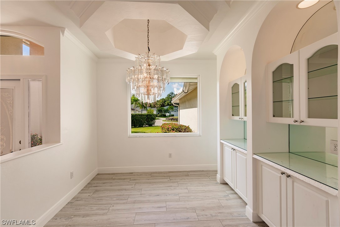 20600 Rivers Ford Estero, FL 33928 - Photo 3 of 28 a view of a room with wooden floor and chandelier