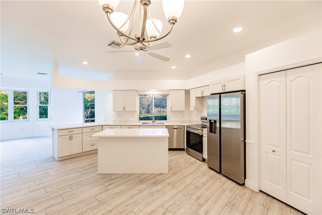 20600 Rivers Ford Estero, FL 33928 - Photo 5 of 28 a kitchen with a refrigerator a stove cabinets and living room view