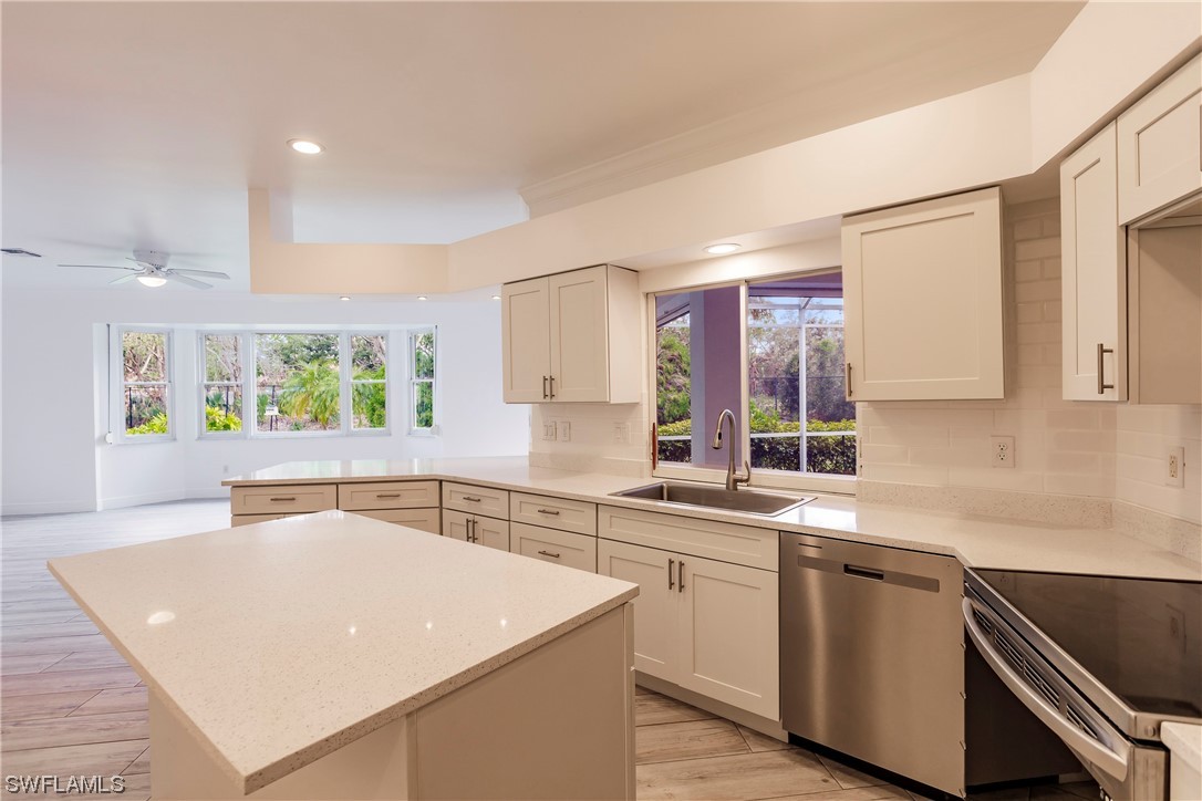 20600 Rivers Ford Estero, FL 33928 - Photo 7 of 28 a kitchen with a sink a stove and cabinets