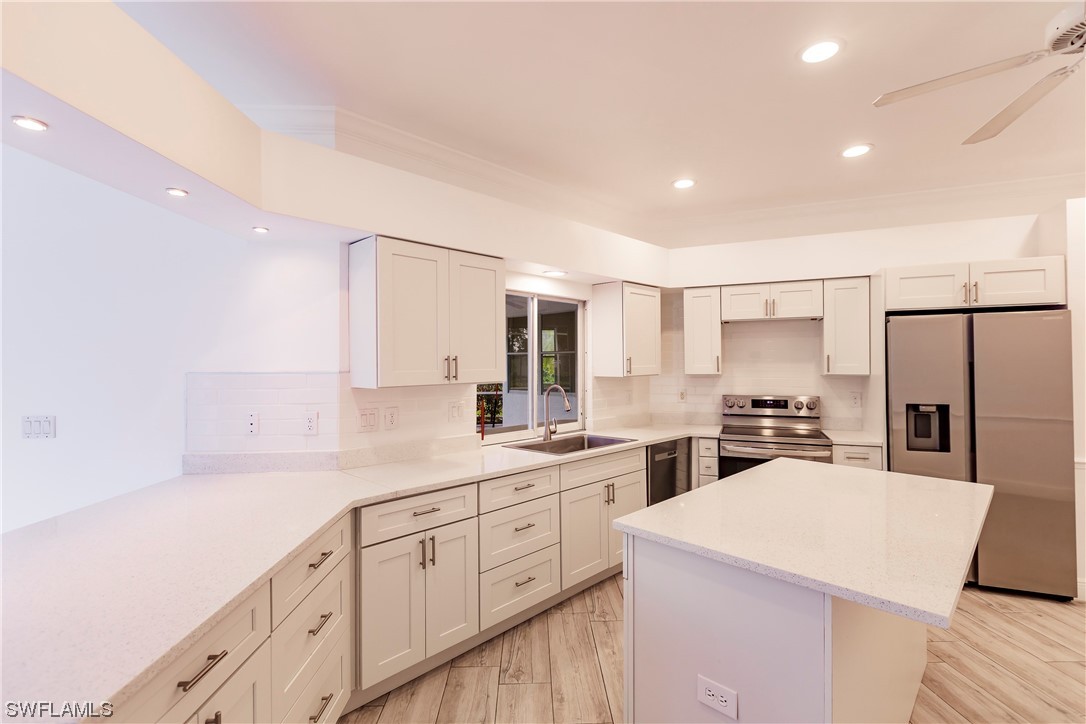 20600 Rivers Ford Estero, FL 33928 - Photo 8 of 28 a kitchen with counter top space sink stove and refrigerator
