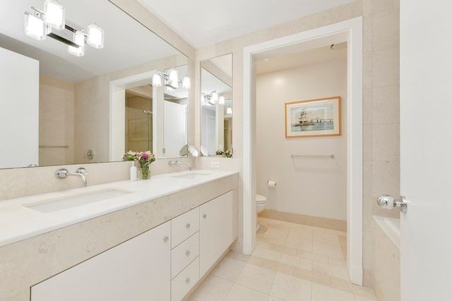 a bathroom with a double vanity sink mirror and double