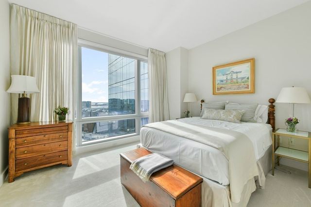 a bedroom with a bed and a night stand