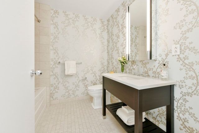 a bathroom with a sink a toilet and a mirror