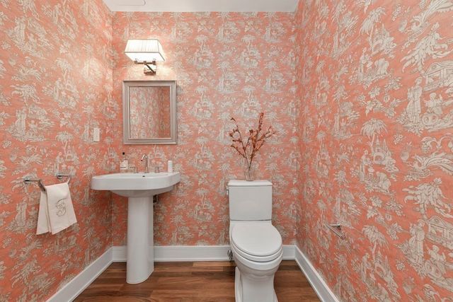 a bathroom with a sink a toilet and mirror