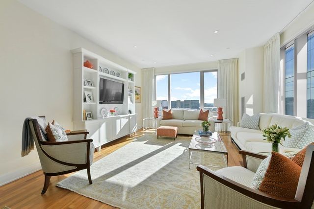 a living room with furniture wooden floor and a flat screen tv