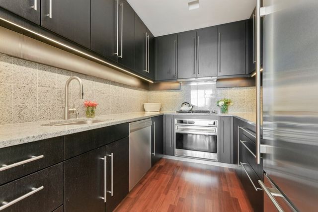a kitchen with stainless steel appliances granite countertop a sink and cabinets