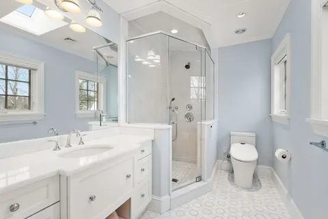 a bathroom with a sink toilet and shower