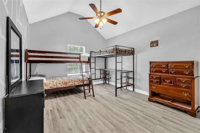 a bedroom with furniture and a wooden floor