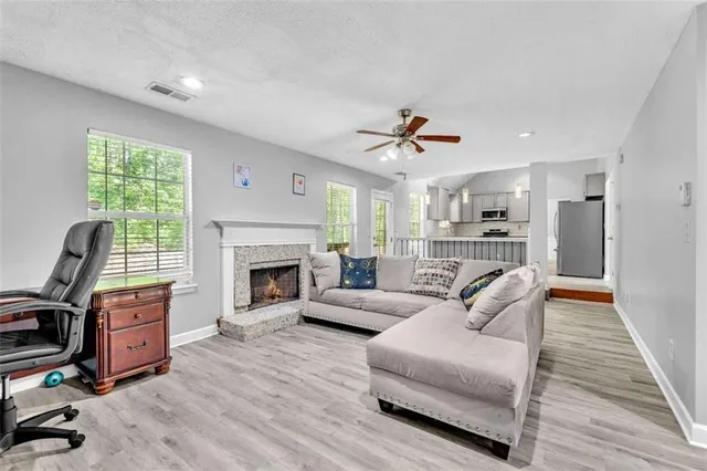 a living room with furniture a fireplace and a flat screen tv
