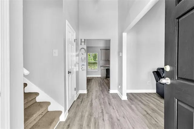 a view of a hallway with wooden floor and stairs