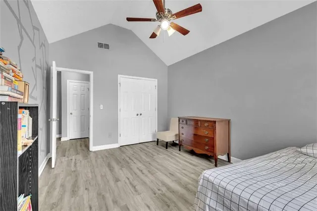a bedroom with bed and wooden floor