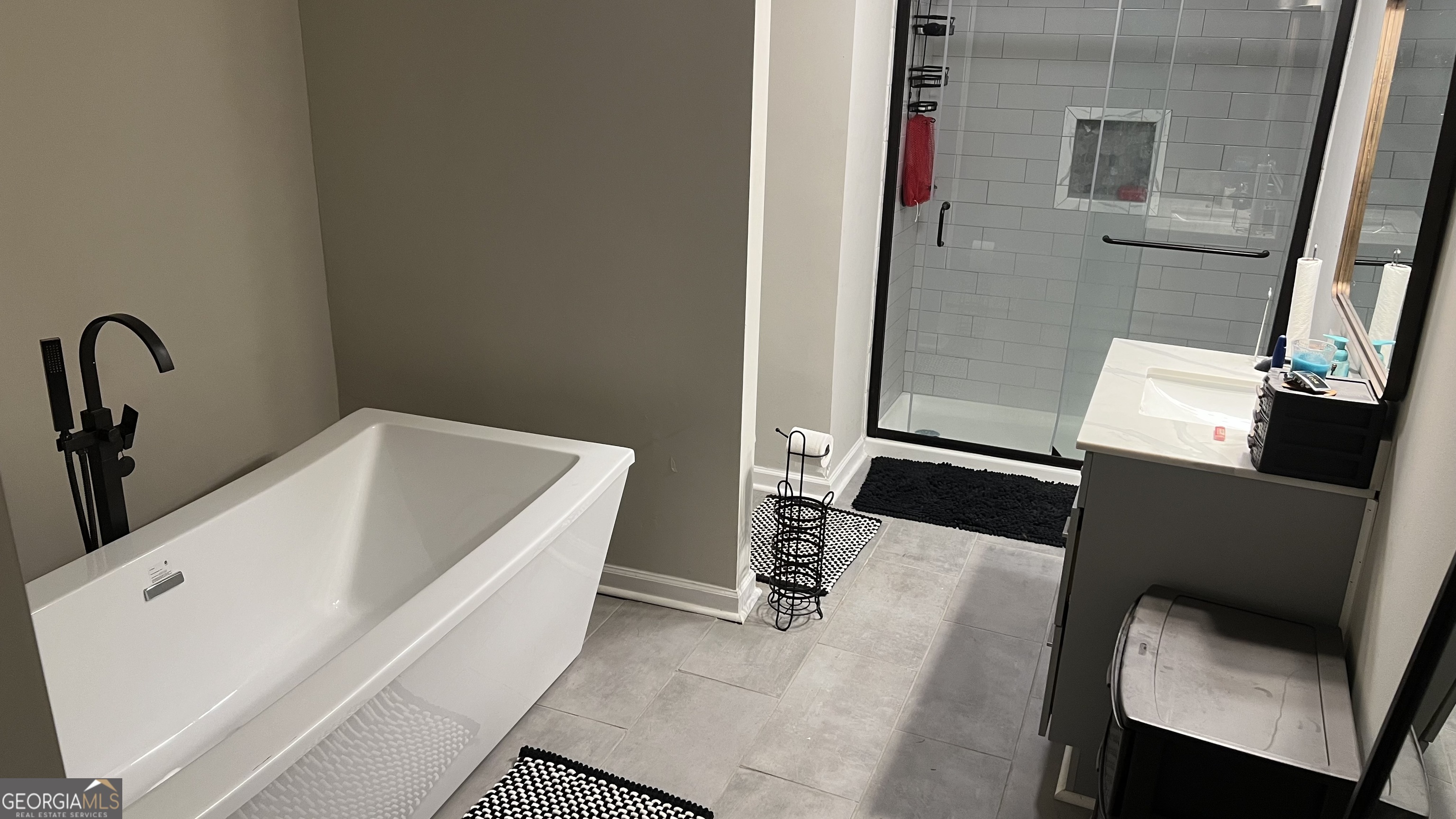 1065 Nathan Jones Road Harlem, GA 30814 - Photo 27 of 32 a bathroom with a tub sink and a mirror