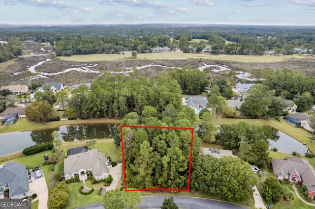 an aerial view of lake and residential houses with outdoor space