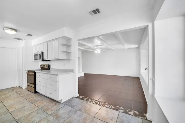 a kitchen with white cabinets and white appliances