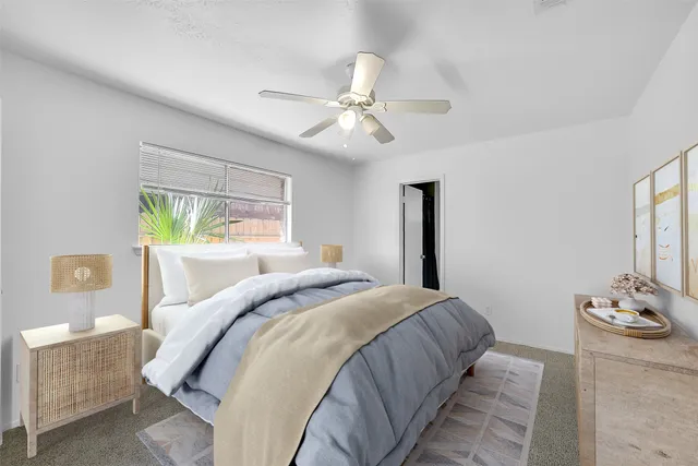 a bedroom with a bed and ceiling fan
