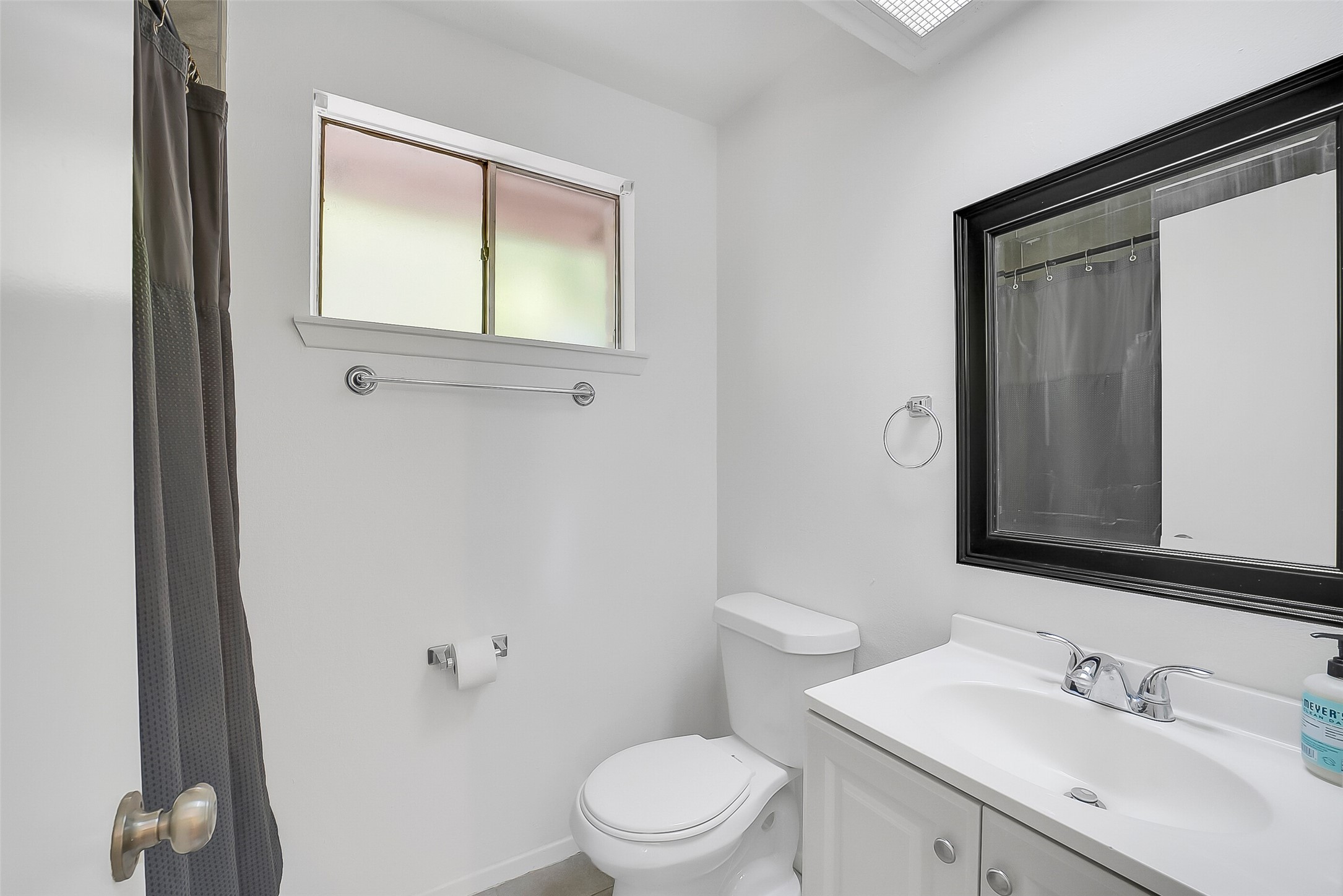 23123 Lestergate Drive Spring, TX 77373 - Photo 14 of 24 a bathroom with a toilet a sink a mirror and a window