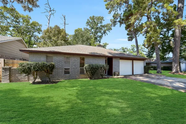a view of a house with a yard and tree