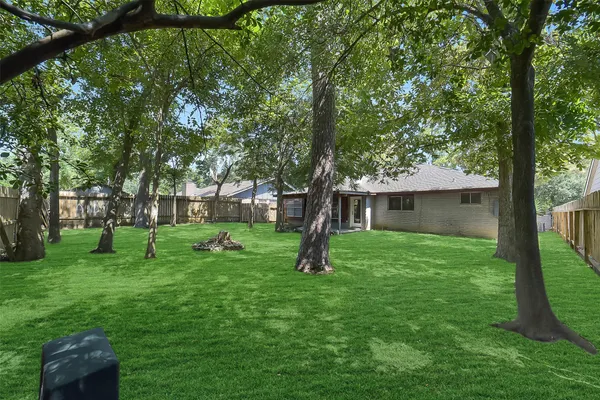 a view of a backyard with a garden and trees
