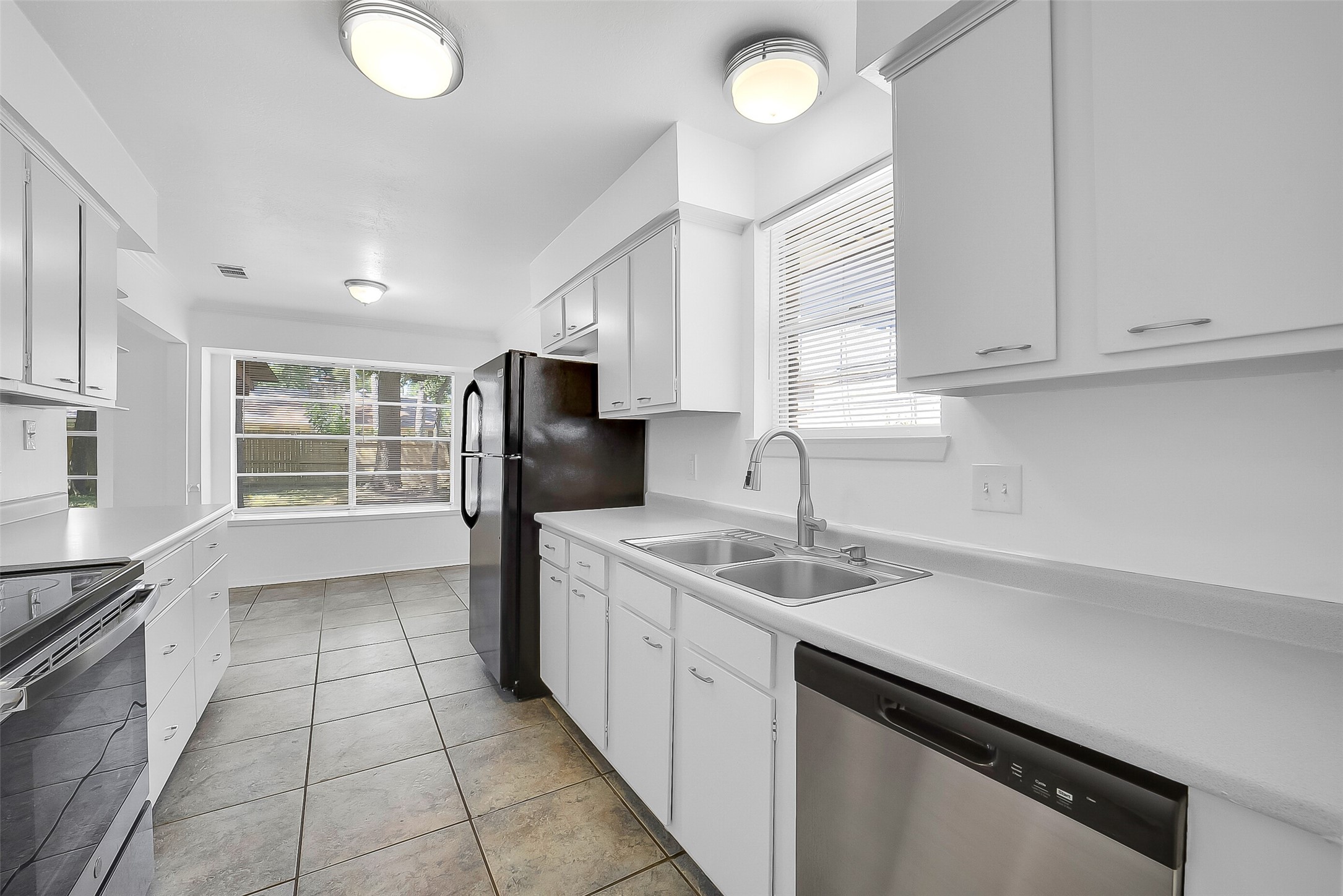 23123 Lestergate Drive Spring, TX 77373 - Photo 6 of 24 a kitchen with a sink window and refrigerator