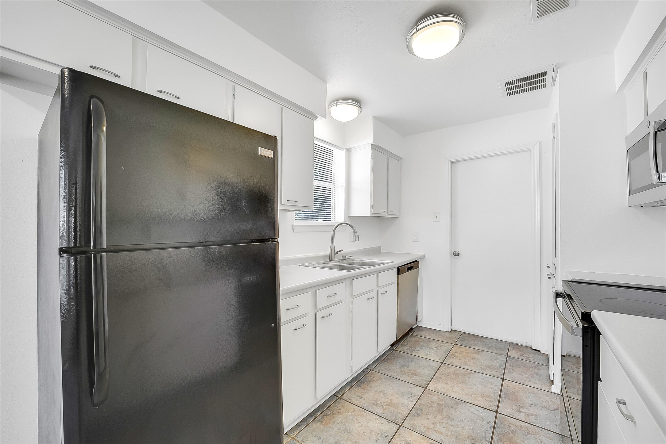 23123 Lestergate Drive Spring, TX 77373 - Photo 7 of 24 a kitchen with a refrigerator and a sink