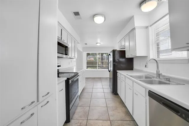 a kitchen with a sink and a stove