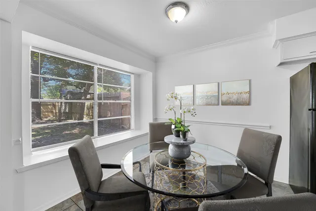 a view of a dining room with furniture window and outside view