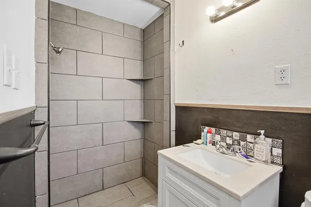 a bathroom with a sink toilet and shower