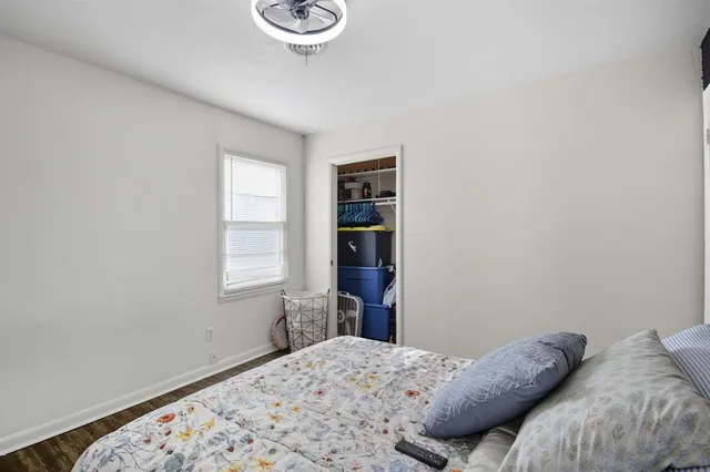 a bedroom with a bed and a window