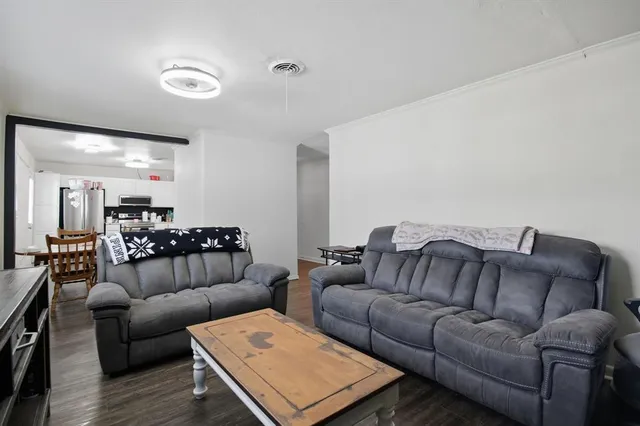 a living room with furniture and stairs