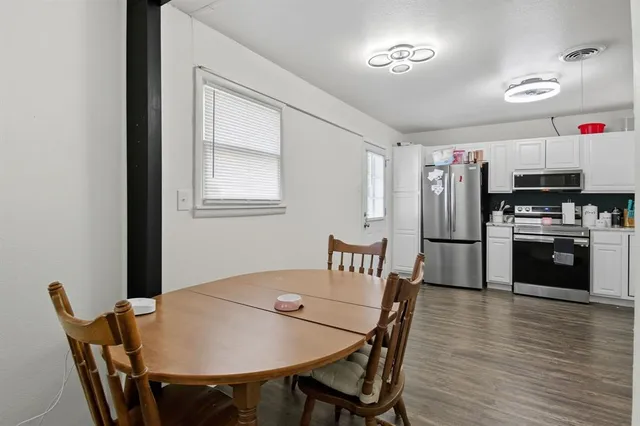 a view of a dining room with furniture and wooden floor