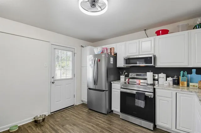 a kitchen with stainless steel appliances a stove microwave and refrigerator